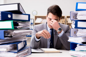 Busy businessman under stress due to excessive work