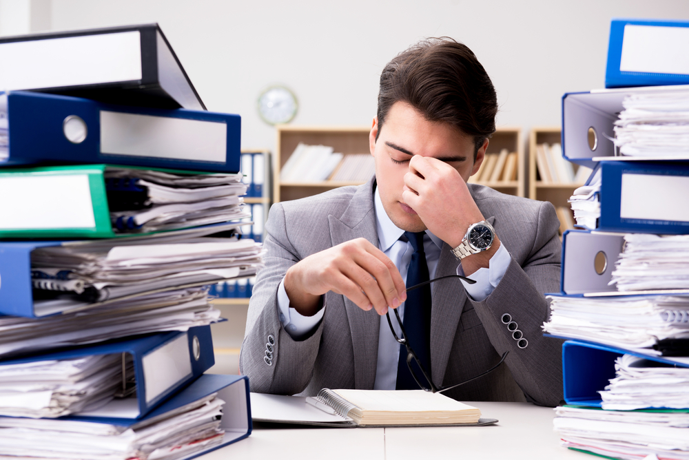 Busy businessman under stress due to excessive work