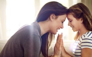 Bonding, love and smile of mother with daughter in home living room for safety, security or trust.