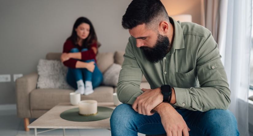 A couple sits apart at home while considering whether a trial separation can help a marriage.