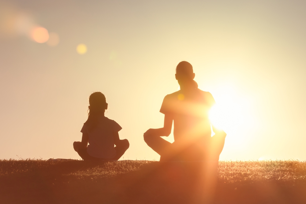 Mother, child sitting in park in the morning sunshine, Family support, trust together, bonding in nature, Love, motherhood, parent help child concept