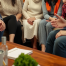 a diverse Utah family sitting together in a warm living room with a legal professional offering guidance.