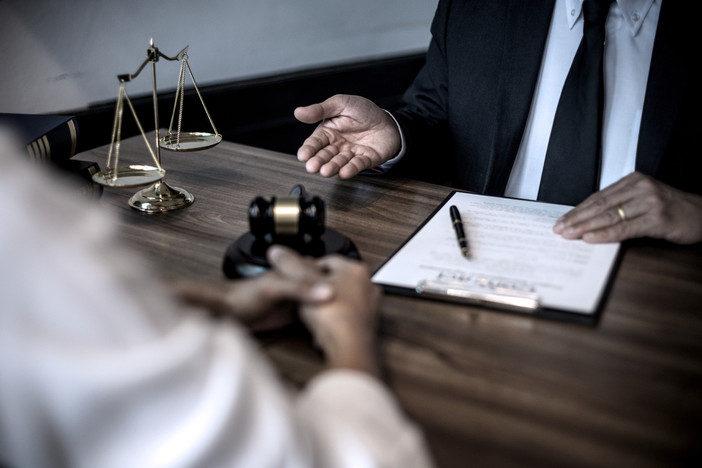 Lawyer or judge are discussion consultation and advice about law gavel and scales on the table in law firm sepia vintage tone.