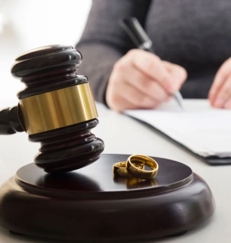 A judge presides over a divorce trial in a courtroom.