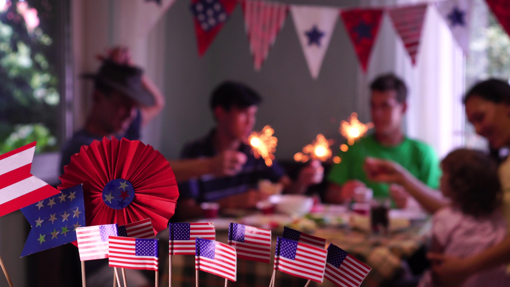 The Fourth of July Celebrations in the USA. Festive food and holiday. The happy American family is celebrating, talking and eating together