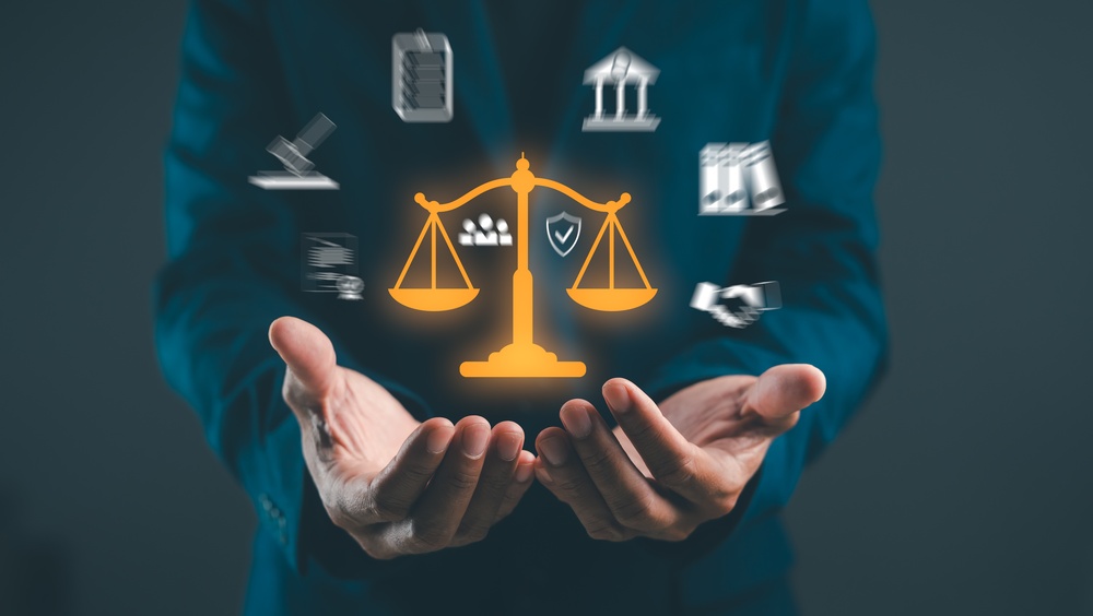 A person holds a scale icon surrounded by legal symbols, representing justice, law, and balance in the legal profession.