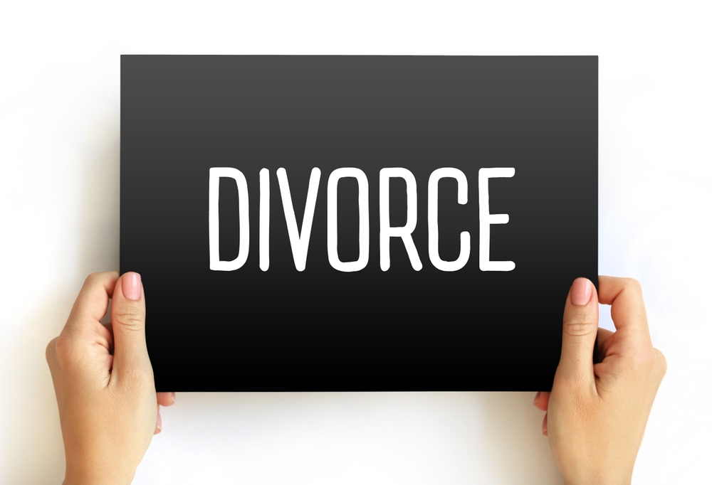 Divorce - canceling or reorganizing of the legal duties and responsibilities of marriage, text concept on card