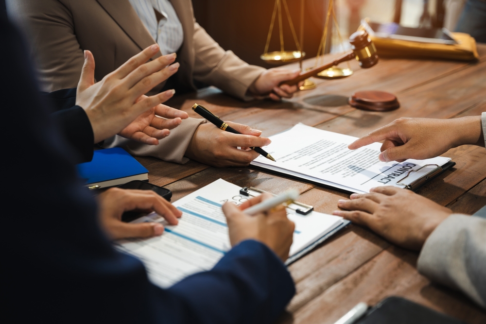 Teamwork of business lawyer meeting working hard about legal legislation in courtroom to help their customer.