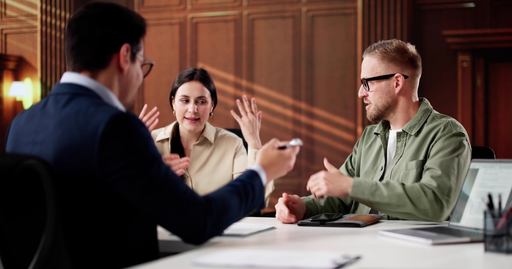 Young Couple Meeting With Family Divorce Lawyer For Financial Consulting.