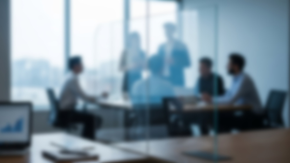 Blurred business meeting with diverse team planning strategy.