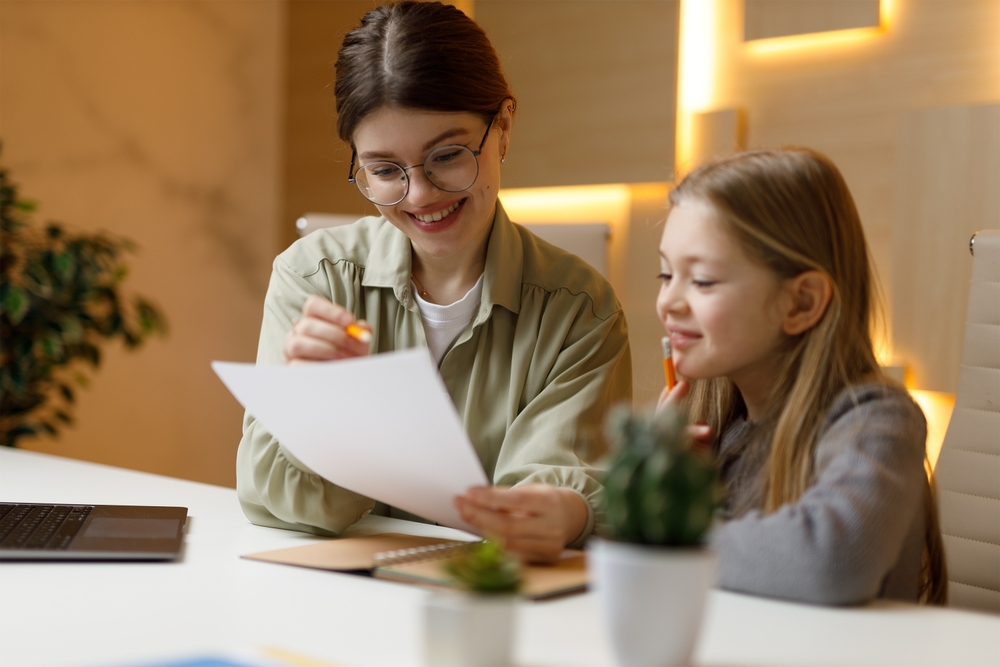 Tutor in a private lesson with a small child of a girl.