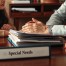 A family lawyer sits with a child with special needs, offering a calm and supportive presence in a professional setting.