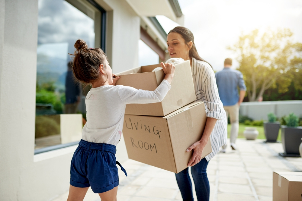 Mother, girl and helping with boxes at new house for property investment, relocation support and security.