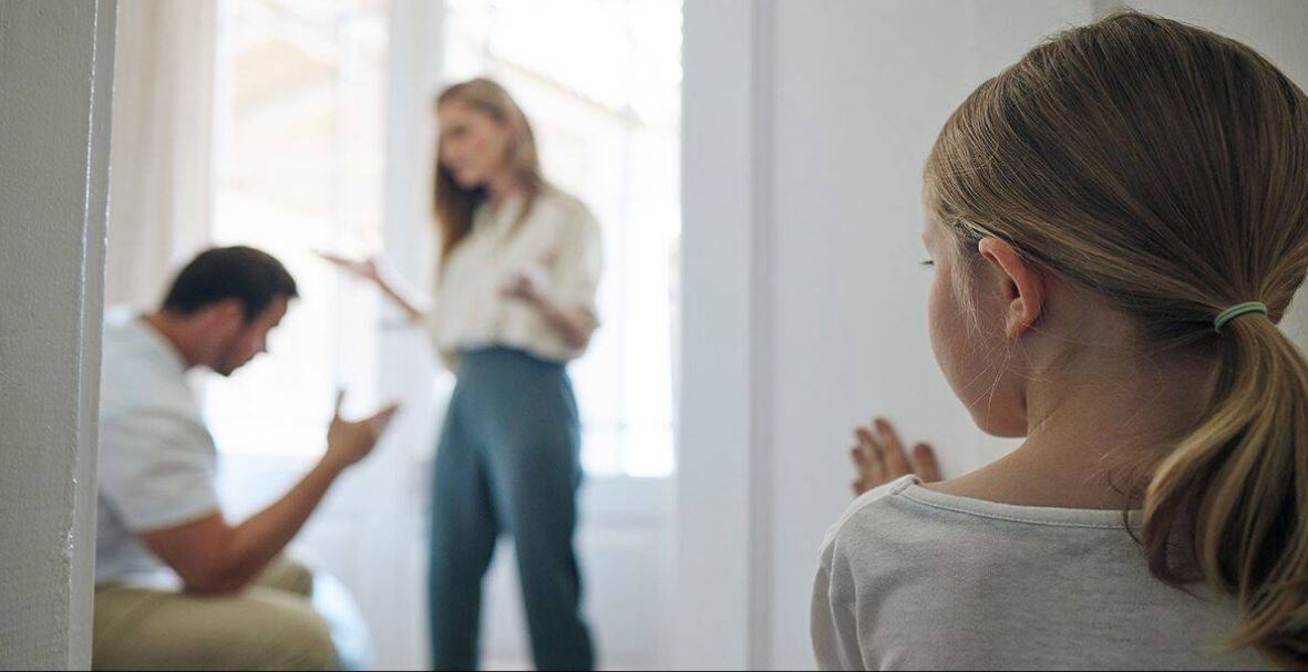 Parents discussing divorce with a child present.